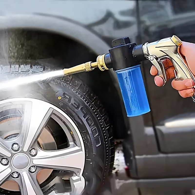Washing gun in use cleaning car tyre